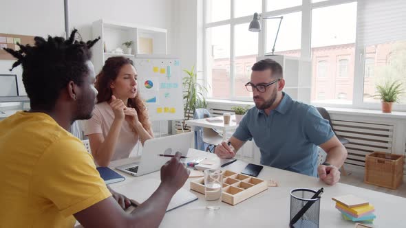 Three Coworkers Having Discussion alt