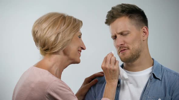 Smiling Mom Wiping Mouth to Infantile Adult Son, Overprotection Effect ...