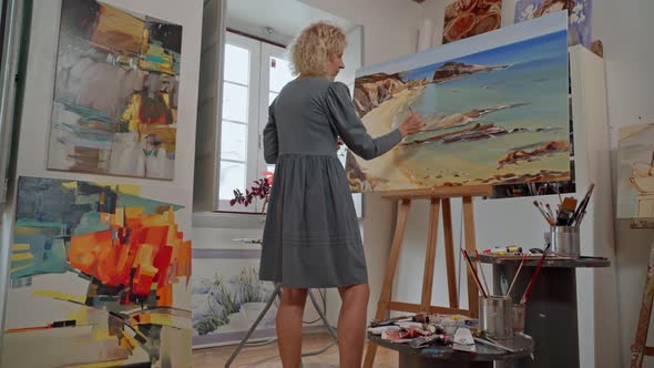 Woman Artist of Drawings Preparing to Create a Abstract Painting Image alt