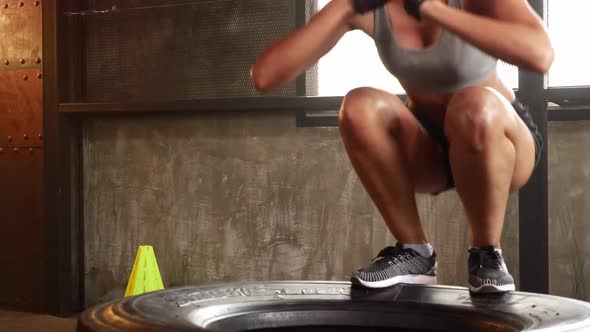 Sporty woman exercising building muscles at the gym alt