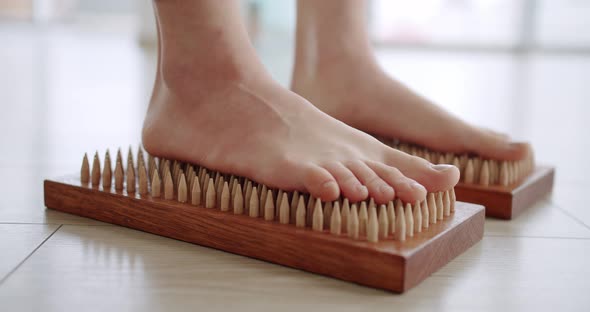 Women Feet on a Sadhu Board Doing Relaxation Exercisecloseup alt