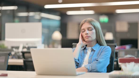 Upset Young Woman Worried While Sitting in Office alt