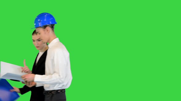 Female Manager and Male Engineer Walk Discussing on a Green Screen Chroma Key