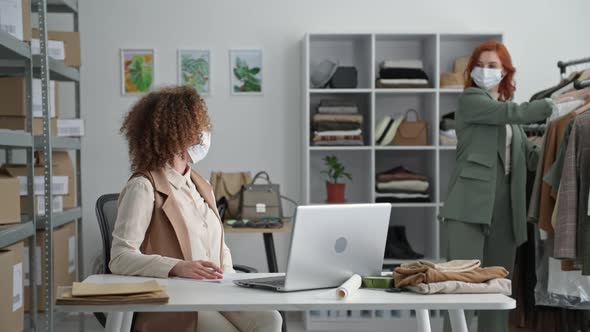 Online Shopping Young Businesswoman and Her Colleague Sell Goods Via Internet and Show Dress Via alt