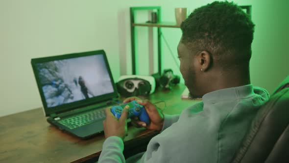 Happy Afroamerican Man Playing Computer Game Pad  Medium Shot alt