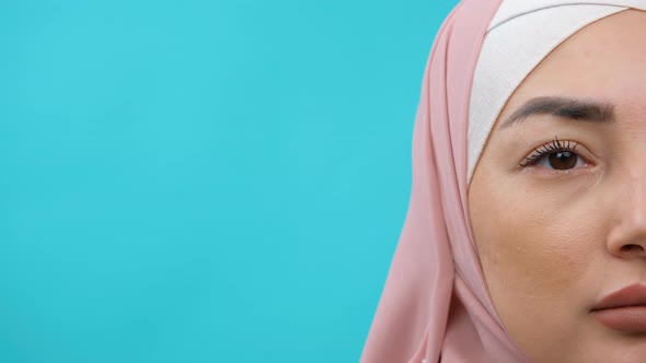 Close Up of Face of Young Muslim Woman Wearing Black Hijab Standing and Looking at Camera