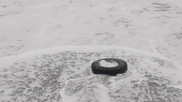 Abandoned Used Truck Tire On Coastline On The Black Sea Coast