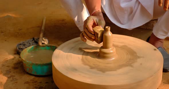 Pottery - Skilled Wet Hands of Potter Shaping the Clay on Potter Wheel. Pot, Vase Throwing alt