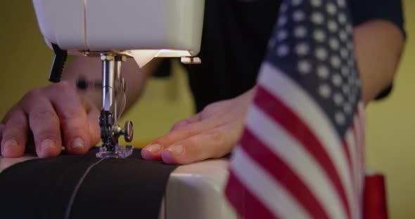 Tailor Sewing Next to an American Flag 30b