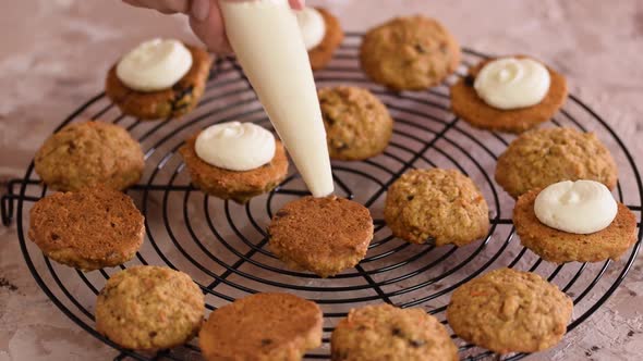 Confectioner Decorating Cookies with Cream