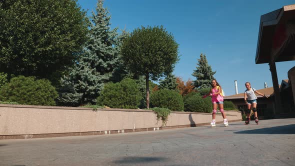 Young Active Teenage Girls Roller Skating Outdoor alt