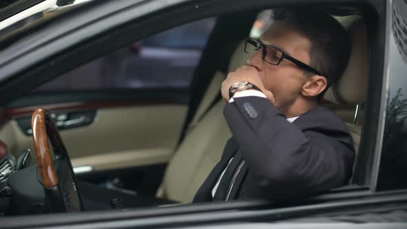 Sleepy Businessman Yawning in Car, Holding Wine Bottle, Hangover, Accident Risk alt