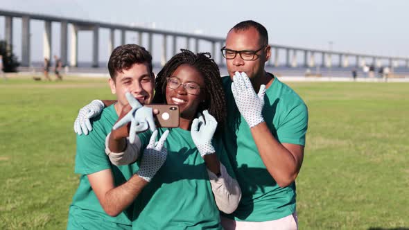 Happy Volunteers Taking Selfie with Smartphone alt