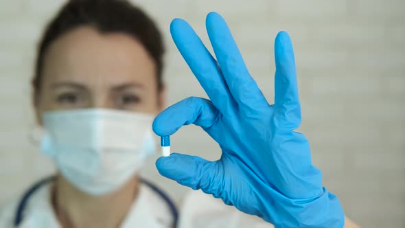 Therapist Holding Medicine Capsule alt