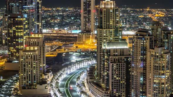 Top View of Road in Dubai Downtown Timelapse with Night Traffic and Illuminated Skyscrapers alt