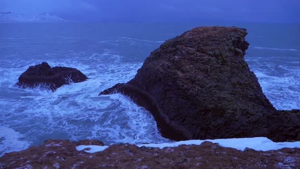 Iceland Rough Ocean Water Crashes Against Large Cliffs In Arnarstapi alt