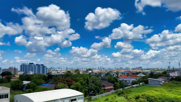 Blue cloudy sky at summer day with Urban forest and Bangkok city downtown