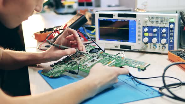 Young Specialist is Measuring Tension in a Circuit alt