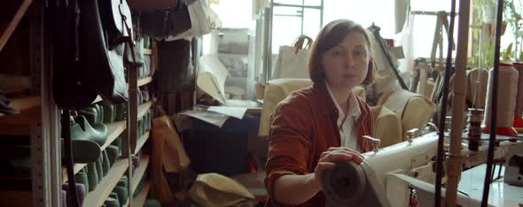 Portrait of Woman with Sewing Machine in Shoemaker Workshop alt