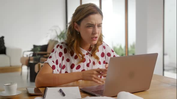 Woman Using Laptop at Home Frustrated Shocked After Reading Bad Online News alt