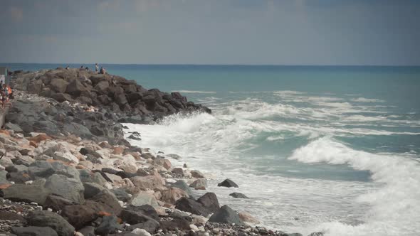 Front View of Sea Waves Breaking on Rocks. Rock with the Big Stones in the Sea and Waves with Foam. alt