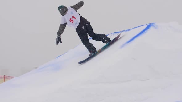 SLOW MOTION: Young Pro Snowboarder Big Air alt