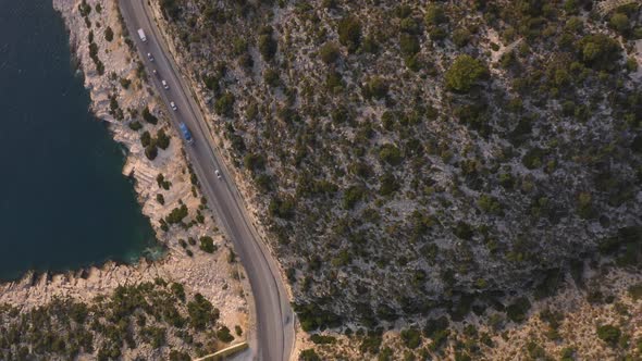 Aerial View of Highway Road Along Mountains and Blue Ocean alt