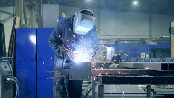 Specialist Is Welding a Metal Beam with a Cutting Tool alt