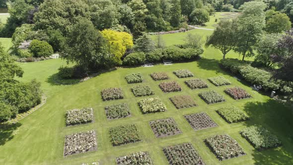 Drone Slowmotion of an Dutch Flower Garden during Spring, with lots of Flowers and Green Trees alt