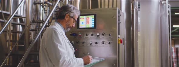 Scientist in white coat taking notes alt