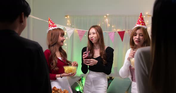 Slow motion of happy young Asian friends spending free weekend time for night party together. alt