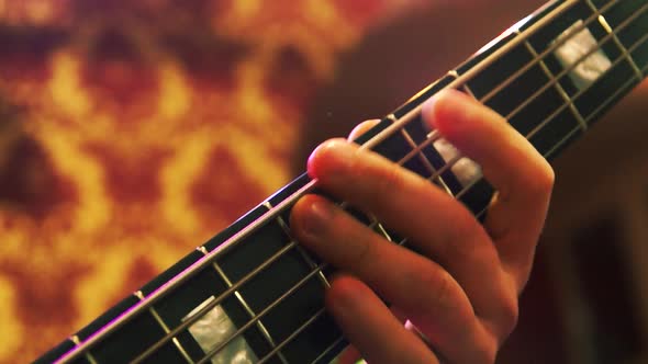 Fingers plays the bass guitar