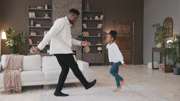 African Family Dancing in Living Room Celebrate Moving Day alt