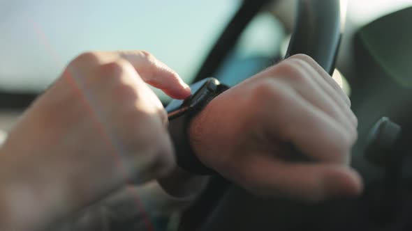 Close-up Male Hands Using Modern Smart Watch in Car