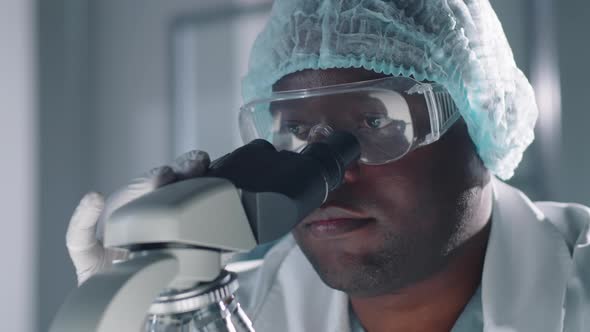 Medical Scientist With Microscope alt