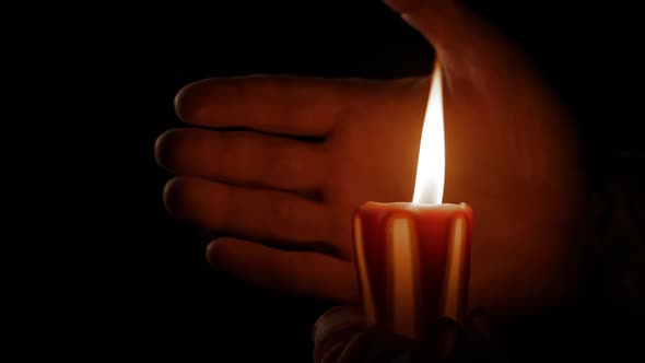Burning Candle and Human Hand alt