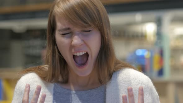 Portrait of Screaming Young Woman, Shouting in Cafe alt