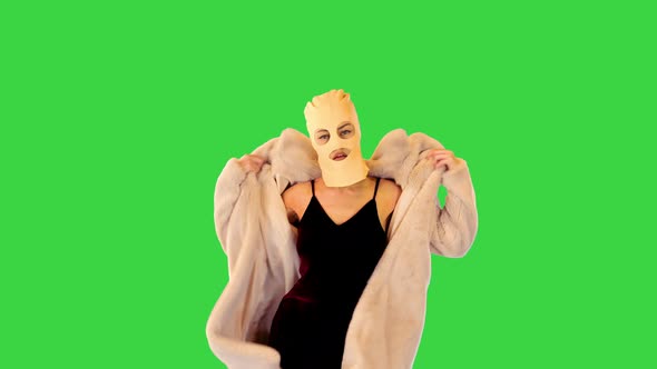Young Caucasian Girl in Balaclava Walks Confidently Making Energetic Hand Gestures on a Green Screen