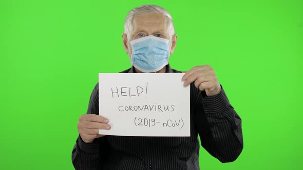Elderly Grandfather Man in Medical Mask Show Page with Message. Coronavirus alt