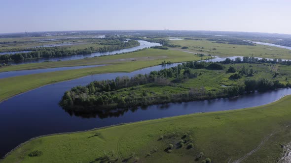 Scenic Aerial View of a River and Green Fields in a Countryside