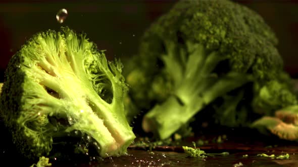Super Slow Motion on the Pieces of Broccoli Drop Water Droplets alt