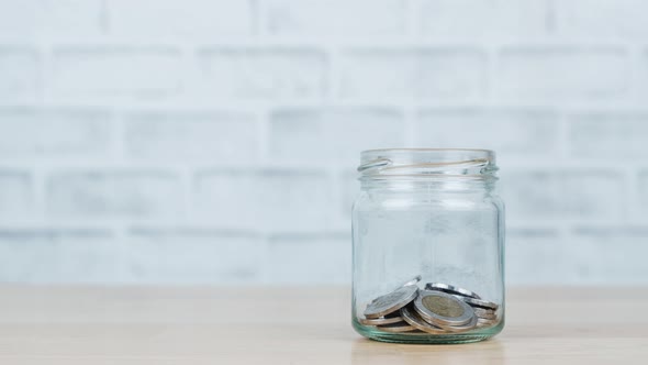 Stop motion animation Saving money concept.Money on glass jar.