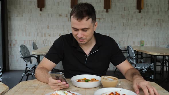 Smiling Male with Smartphone in Hand Take Lunch in Cafe Eat Pizza with Coffee alt