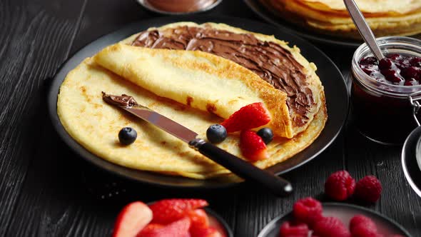 Delicious Chocolate Homemade Pancakes on Black Ceramic Plate