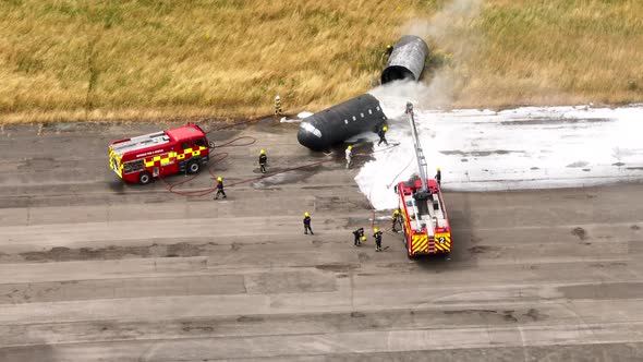 Firefighters Training to Tackle a Fire of a Dummy Aircraft alt