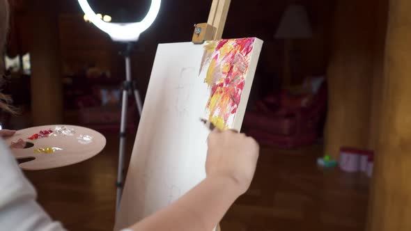 Artist Using a Palette Knife Paint Colorful Picture Ring Light Scene