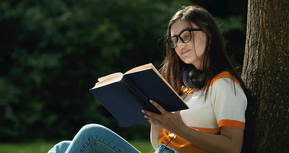 Woman with Book Relaxing in Park