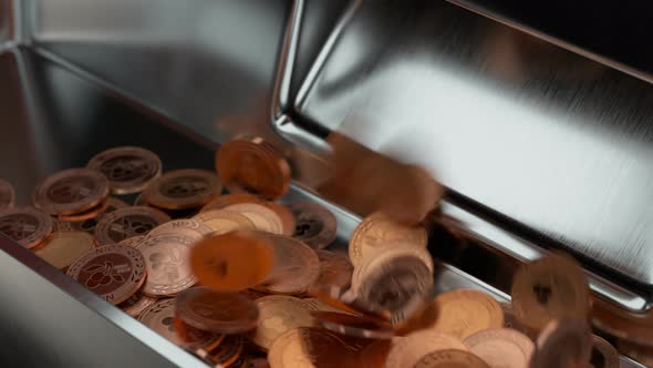 Casino slot machine winner payout. Rose gold or copper coins falling int tray. alt