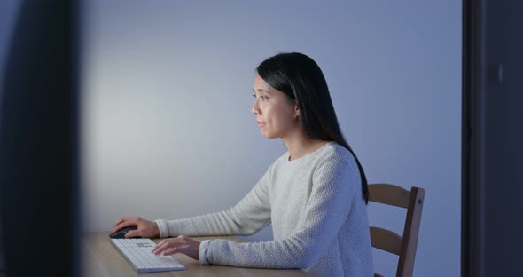 Woman work on computer at home in the evening alt