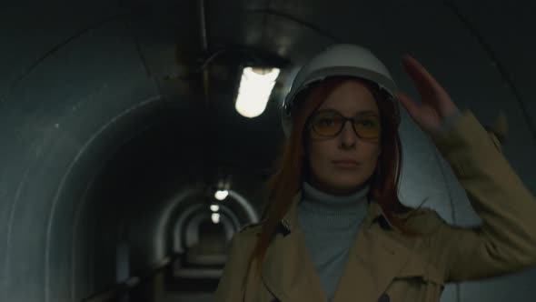 Businesswoman in helmet going through the tunnel